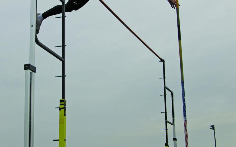 Sentinel Photo/Mike Reddell Blackcat Ty Schneider clears the top bar in the pole vaulting competition with a West Columbia vaulter.