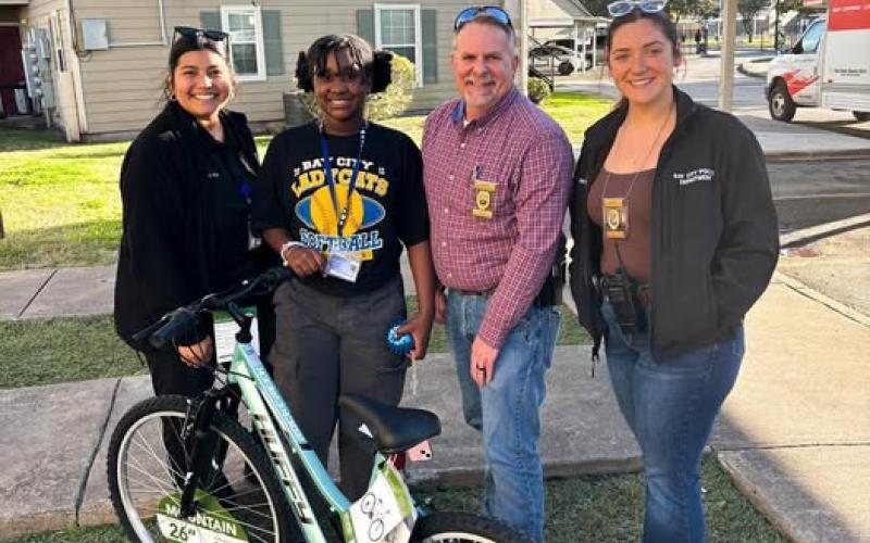 Courtesy photo Shop with a Cop presented this young lady with a brand new bike after they heard her bike was taken and destroyed.