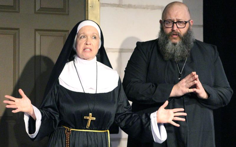 Sentinel Photo/Jessica Shepard Mother Superior (Stacey Steiner), left, and “Father” Paul (Clay Breeden), work out their plan to discover the secret reports a newly appointed nun will send to Rome in CAST’s “Drinking Habits” press night Thursday, March 6.