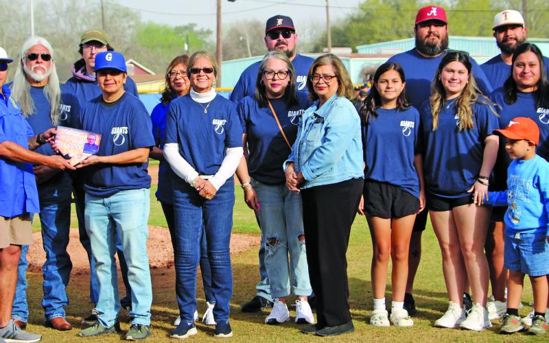 Sentinel Photo/Jessica Shepard Bay City Little League recognized Henry Charles for his years of support during the league's opening ceremony March 15. Little League President James Cadenas presented the Charles family with a plaque on the pitcher's mound.