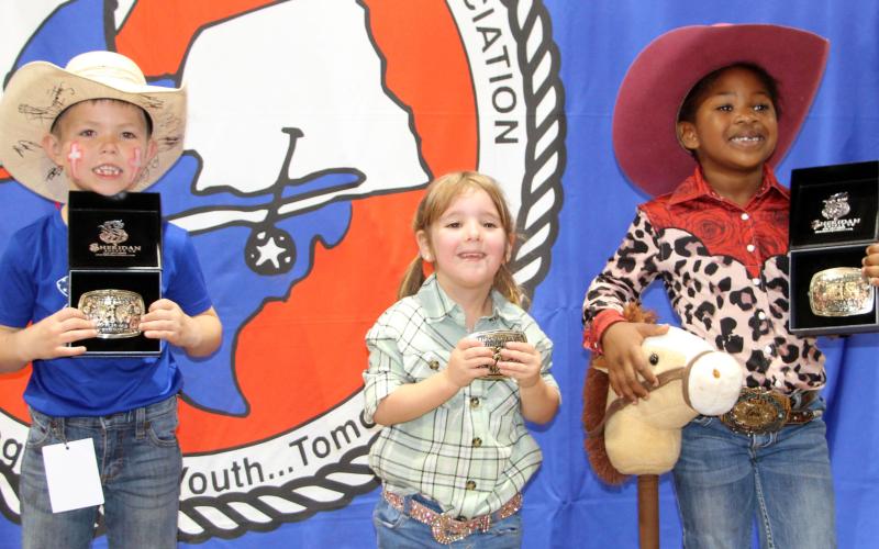 Sentinel photo by Jessica Shepard Three age division buckle winners were chosen for Matagorda County Fair &amp; Livestock Association's first "Little Rodeo" last week. Banks Busby, Ellison Russell, and Londyn Gatson won buckles in the 6-7, 2-3, and 4-5 age divisions respectively. Each child had to retrieve a ribbon tied around a lamb's tail and race their stick horses in the competition.