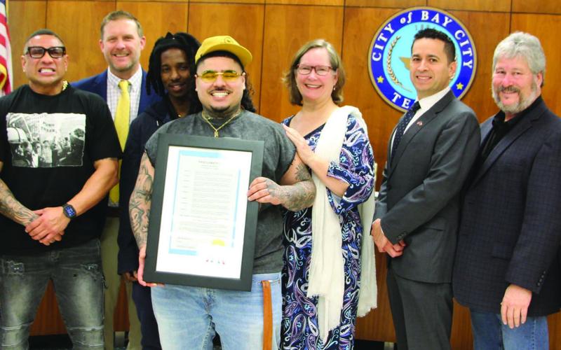 Sentinel Photo/Jessica Shepard The City of Bay City proclaimed Feb. 25 as “That Mexican OT Day” at the start of the city council meeting on Feb. 25. That Mexican OT - Virgil René Gazca, center, holds a framed copy of the proclamation.