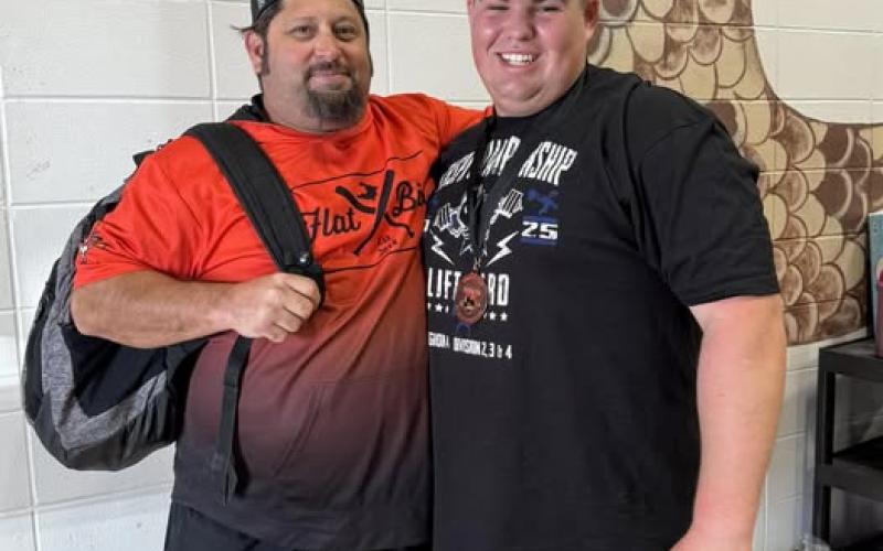 Contributed photo Van Vleck High School sophomore Cole Newell, right, with Powerlifting Coach Henry Ashworth, punched his ticket to the state powerlifting meet in Abilene. Newell set a new 545-pound bench press record as well.
