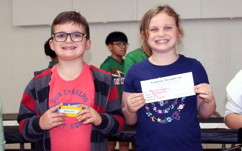 Sentinel Photo/Jessica Shepard First through fourth place awards were given to, from left, Walker Griffith, Noah Short, Coral Short, and Isabella Espinosa at the annual Bay City Lions Club "Pancake Supper" last Thursday. Each child was given five pancakes and water to drink as they chowed down towards first place. Griffith also won first place at last year's event.
