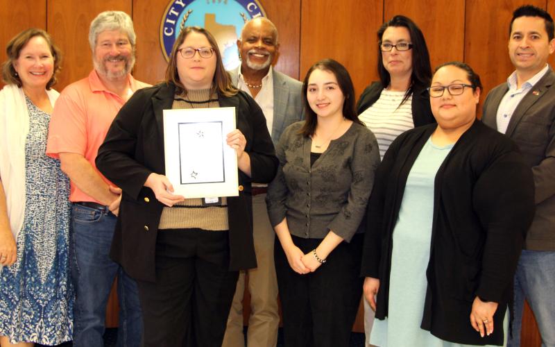 Sentinel Photo/Jessica Shepard City Council members join Bay City Public Library staff for a photo celebrating the library's "2024 Achievement of Library Excellence" award from the Texas Municipal Library Directors Association at the council's regular meeting on Tuesday, March 25.
