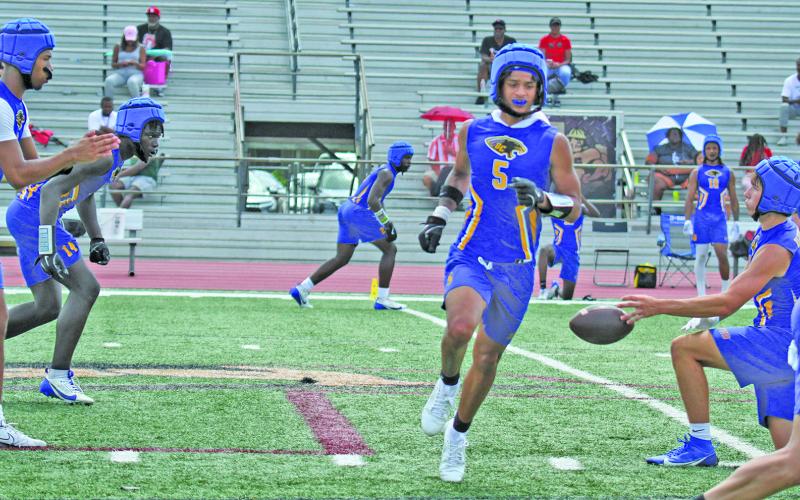 Photo by Anna Hernandez Bay City quarterback Jonus Edwards signals for the ball during the 7 on 7 game in West Columbia Saturday at their first 7 on 7 State Qualifying Tournament.