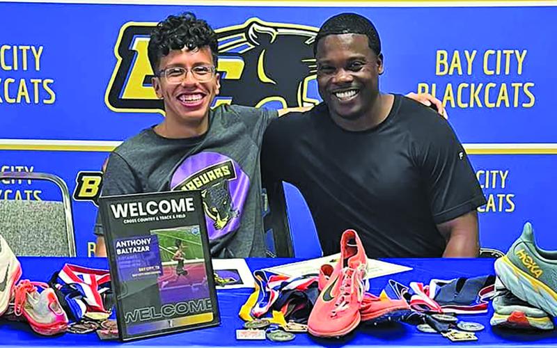 BCHS  photo BCISD Athletic Director Robert Jones, right, celebrated with Blackcat trackster Anthony Baltazar signing with Jacksonville College to compete in Cross Country and Track &amp; Field.