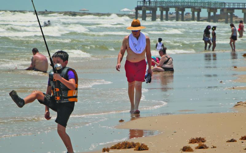 Sentinel Photo/Mike Reddell A young fisherman displays a different kind of fishing technique at Matagorda Beach last Saturday, May 24.