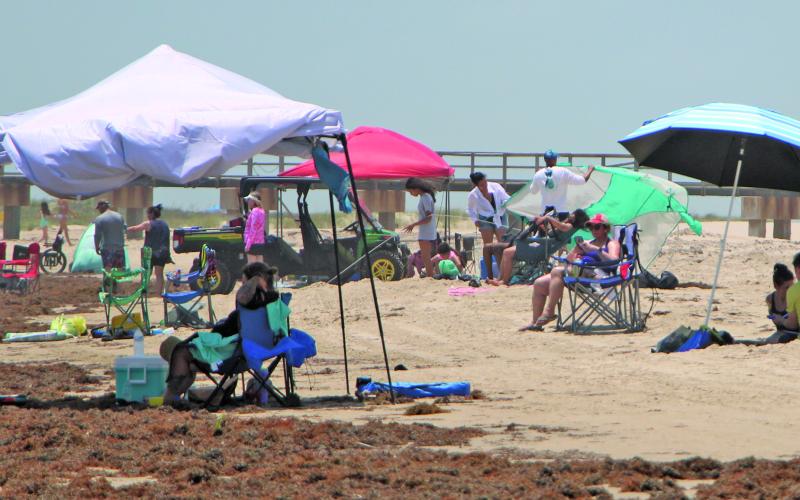 Sentinel Photo/Mike Reddell Some Matagorda Beach visitors put their shelter up a little back from the gulf, in most instances giving them more space to enjoy the sun, sand and sea last Saturday, May 24.