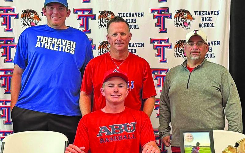 Tidehaven photo Tiger Camden Johnson was joined by Tidehaven coaches recently on his commitment to Arlington Baptist University (ABU) to play baseball.