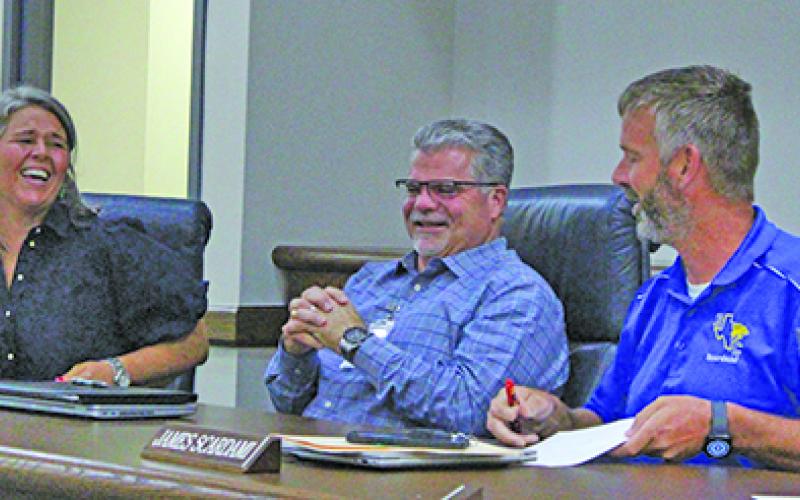 Sentinel Photo/Jessica Shepard New Bay City ISD Superintendent of Schools, Christopher Townsend, center, shared a laugh with BCISD Board President Jill Westmoreland, left, and Board Vice President James Scardami, right, June 10.