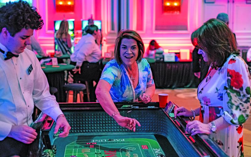 WCJC photo Michelle Bohreer of Bohreer Law Firm rolls the dice at the craps table at the second annual “Blackjack, Glitz &amp; Glamor” fundraising event hosted by the Wharton County Junior College Foundation Saturday, May 31, at the Houston Marriott Sugar Land.
