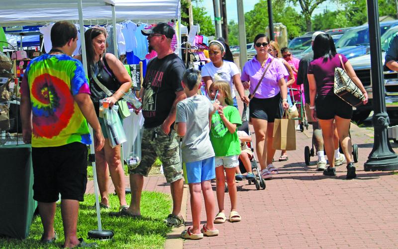 Sentinel Photo/Jessica Shepard Soaring summer temperatures didn't stop Downtown Market Day attendees, above, from viewing a variety of vendors and their wares on Saturday, June 28.