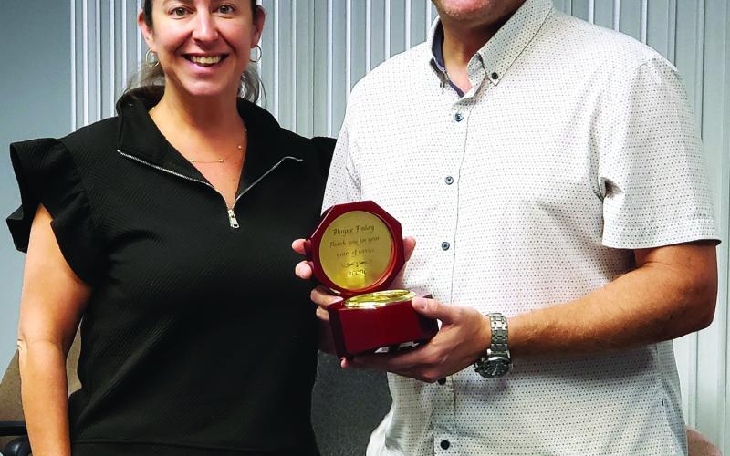 Sentinel photo/Jessica Shepard Bay City Community Development Corporation (BCCDC) recognized former board member Blayne Finlay, right, for his commitment and service while on the board during their monthly meeting Monday, June 30. BCCDC Executive Director Jessica Russell, left, gifted Finlay with a clock on behalf of the board.
