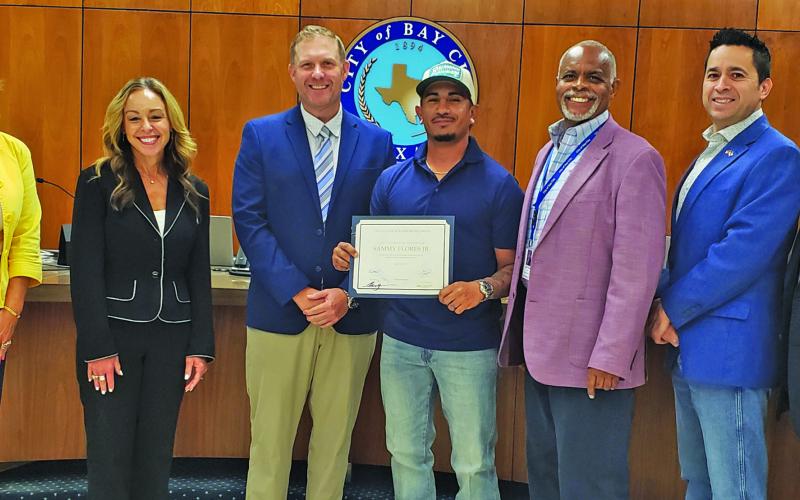 Sentinel Photo/Jessica Shepard City Council recognized Sammy Flores, Jr., center, for his promotion to Equipment Operator during its regular meeting Tuesday, July 8.