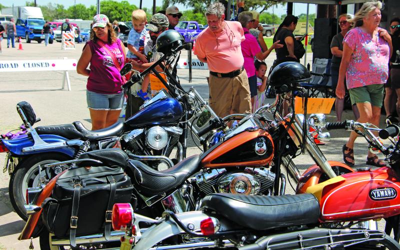 Sentinel Photo/Jessica Shepard A bevy of colorful and unique motorcycles drew a variety of onlookers during the annual Blessing Hotel Car Show on Saturday, July 19.