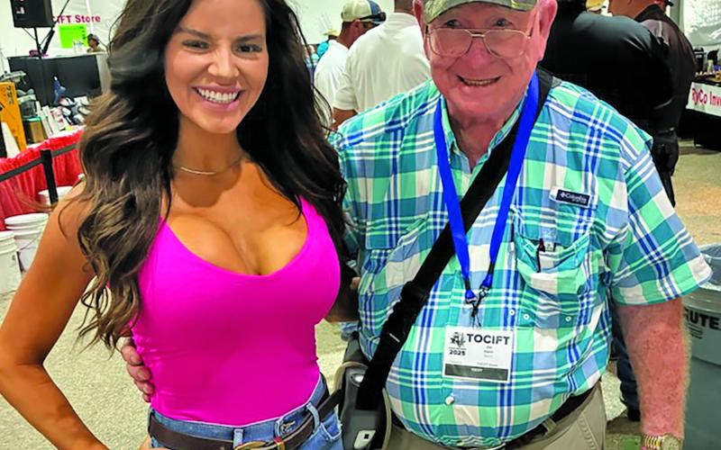 George Deshotels photo Matagorda County resident Jim Gann is shown buying a raffle ticket at the Texas Oilman’s Charity Fishing Tournament at Matagorda Harbor Saturday.