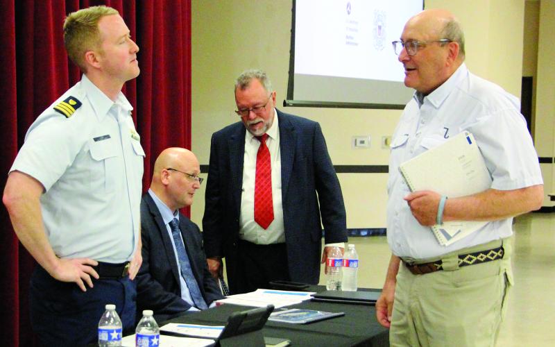 Sentinel Photos/Jessica Shepard At left, US Coast Guard Commander Jake Lobb and Maritime Administration Transportation Industry Analyst Brian Barton led the comment session on the ST LNG deepwater port project last week. Local commenters included Port of Bay City Authority Chairman George Harrison, front right, and Matagorda County Economic Development Executive Director Mike Ferdinand, back right.