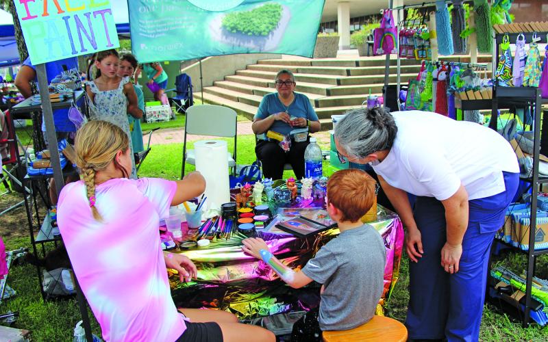 Sentinel Photo/Jessica Shepard A variety of vendor booths converged at Matagorda County Courthouse for the monthly return of "Downtown Bay City Market Days" Saturday, Aug. 23. Among the vendors was a face-painting station, above, that gave children and those young at heart the chance to have a custom work of art painted on their skin.