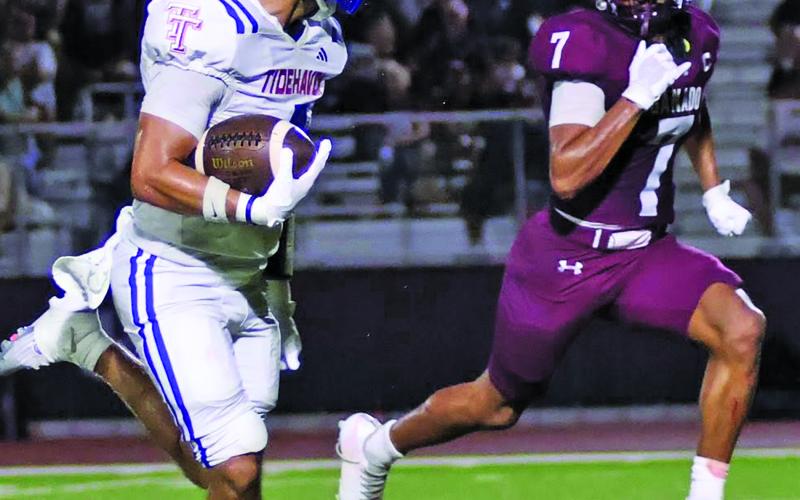 LeDarion Stone/Live in the Moment Photography Tidehaven senior wide receiver Boogie Galvan (3) races downfield with a Ganado defender.