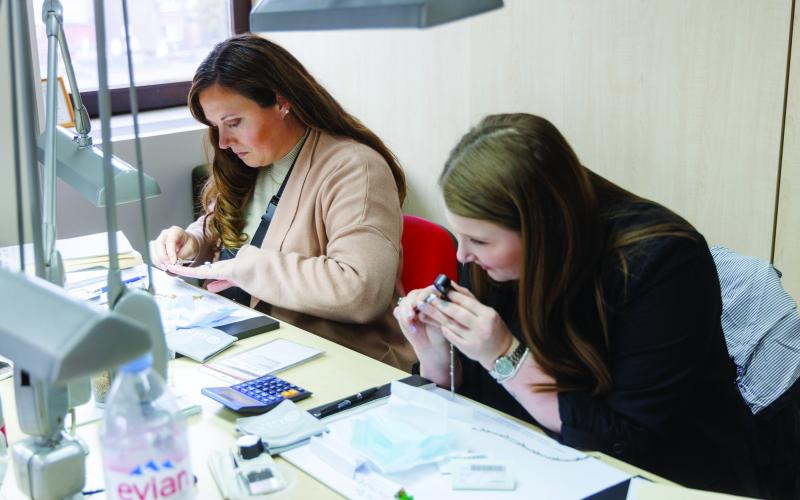Contributed photo Green Brothers Alisha Cornett, general manager, and Madison Evans, Green Brotherers, newest Diamond graduate. work on diamonds at the store.