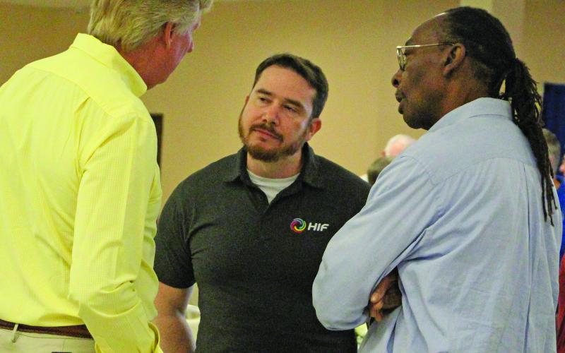 Sentinel Photo/Jessica Shepard HIF-USA Community Affairs and Permitting Manager James Outtrim, center, talks with Nate McDonald, left, and BCISD Trustee Kenneth Eaton during HIF's town hall luncheon Thursday, Sept. 18.