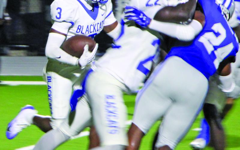 Sentinel Photo/Mike Reddell Blackcat sophomore Braden Jones (3) follows senior James Copeland’s (22) blocking to pick up yards.