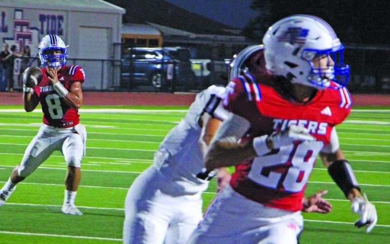 Sentinel Photo/Jessica Shepard Tidehaven receiver Hunter Garcia (28) appears to be getting into position as Tiger quarterback Kale Russell (8) looks for a target.