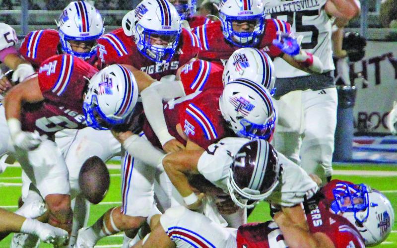 Sentinel Photo/Jessica Shepard A mountain of red Tidehaven jerseys covered this Hallettsville runnng back causing a loose ball.