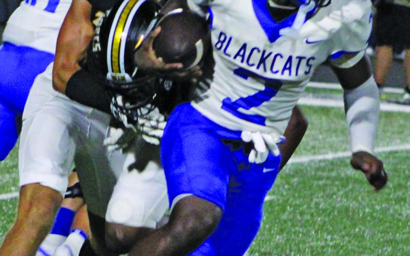 Sentinel Photo/Mike Reddell Blackcat junior Kemarion Wiggins (2) picks up yardage against Sealy. Wiggins led all Bay City rushers with 106 yards.