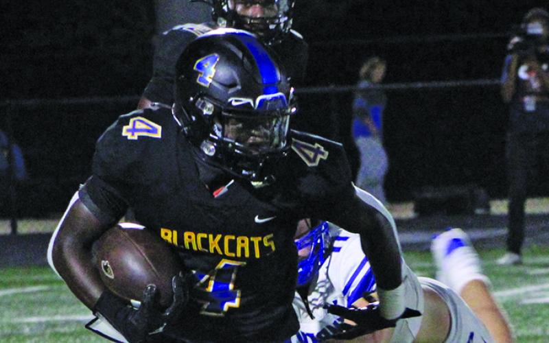 Sentinel Photo/Mike Reddell Bay City junior running back Aiden Williams (4) frees himself from a La Vernia defender to pick up yards.