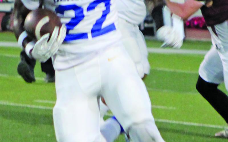 Sentinel Photo/Mike Reddell Bay City back James Copeland (22) picks up yards and a block from junior center Koen Nunez (61) from en route to a game-high 245 yards rushing - and two touchdowns - against Floresville Friday.