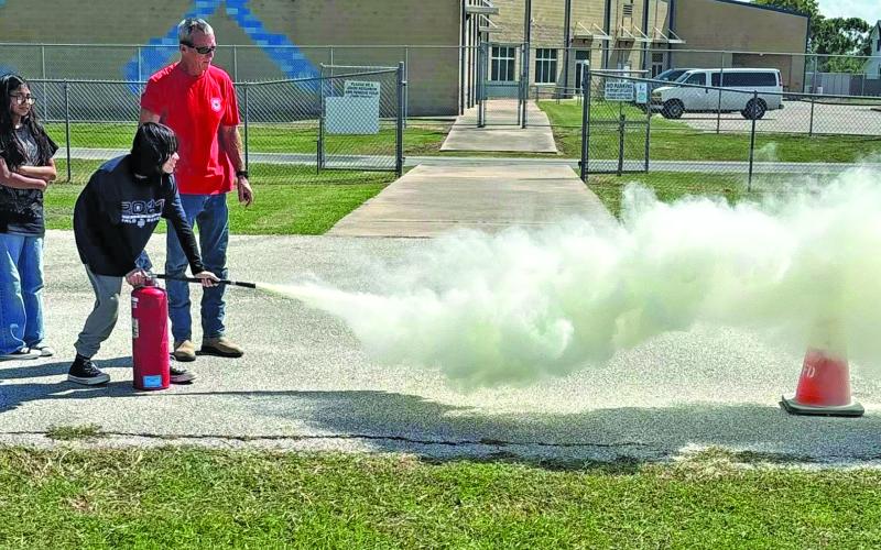 Contributed photo Matagorda Volunteer Fire Department came to Matagorda Elementary School to teach students about fire safety during Fire Prevention Week. The kids put out “fires” with the fire hose and were able to use other methods of fire suppression.