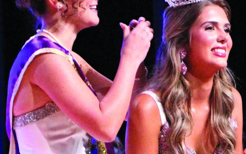 Sentinel photo/Jessica Shepard 2024 Rice Festival Queen Victoria Sliva, left, passes the crown to Bolton.