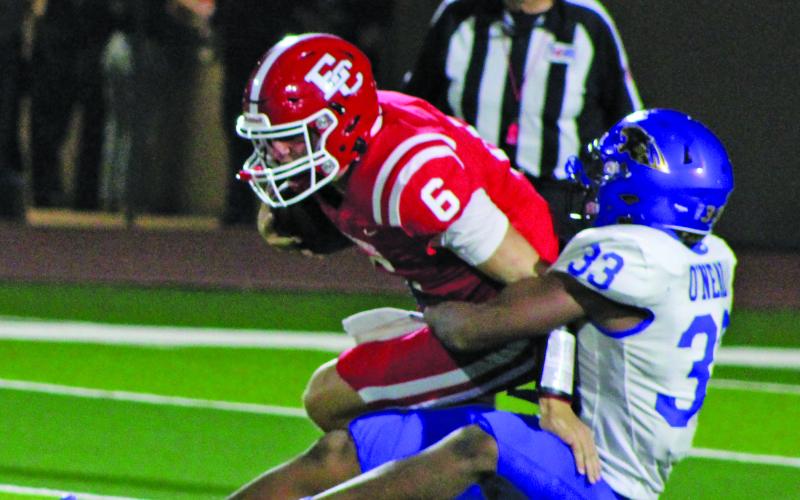 Sentinel Photo/Mike Reddell Senior defensive end Jordan Oneal (33) has a firm grasp of El Campo quarterback Colt Reeve (6) Friday night.