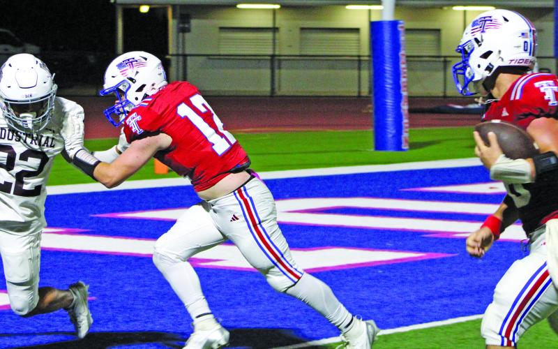 Sentinel Photo/Mike Reddell Tidehaven’s Kale Russell picks up a block before scoring.