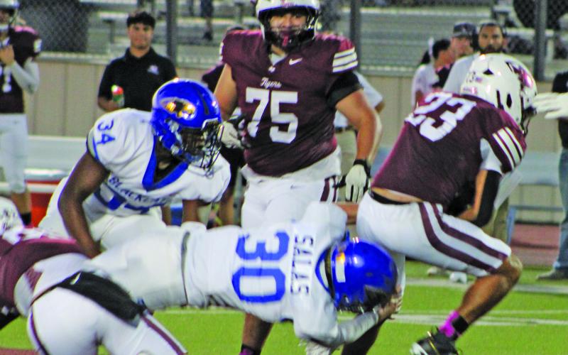 Sentinel Photo/Mike Reddell Blackcat sophomore interior linebacker Wyatt Salas (30) goes horizontal in tackling a Floresville running back in Friday’s game there.