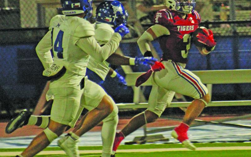 Anna Hernandez photo Tidehaven senior wide receiver TJ Galvan (3) locks in a big gain for the Tigers against Rice last Friday.