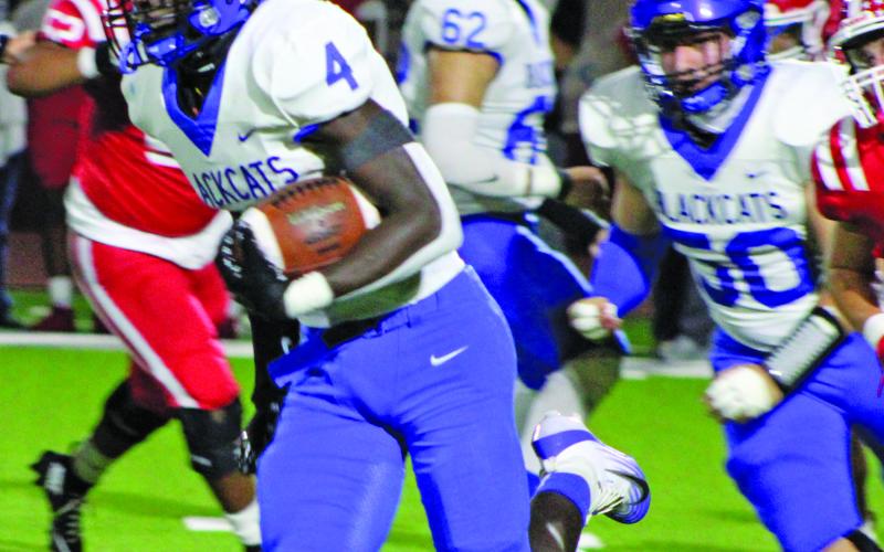 Sentinel Photo/Mike Reddell Bay City junior running back Aiden Williams (4) en route to a 48-yard, third-quarter Blackcat touchdown.
