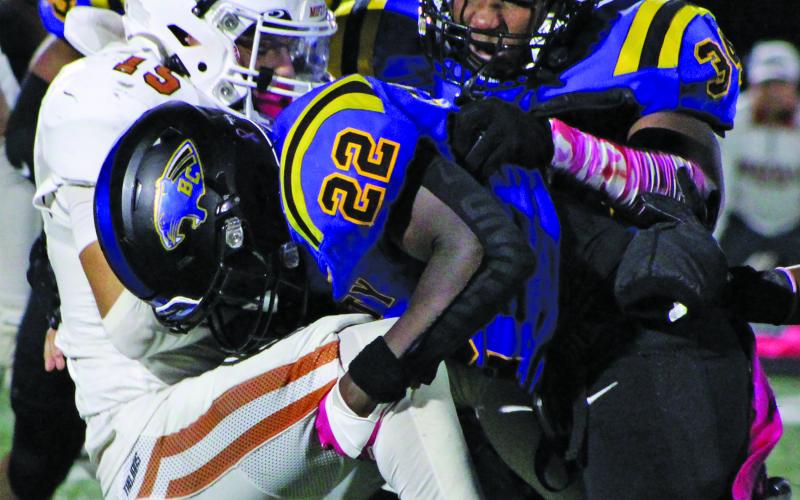 Sentinel Photo/Mike Reddell Senior James Copeland (22) and freshman defensive tackle Kelon Ellis (34) put the squeeze on a Jones running back.