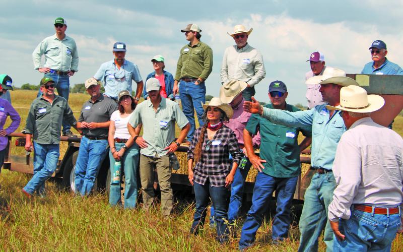 Sentinel Photo/Mike Reddell Adam Sneary, left, points to a pasture at the Sneary Cattle Ranch during a recent field day that covered topics such as different grazing management processes.