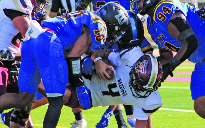 Sentinel Photo/Mike Reddell Senior Davonta Harris (10) and Javon West (94) and other Blackcats converge on the Tuloso-Midway quarterback to bring him down.