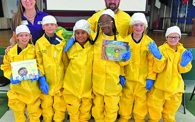 Contributed photo Holy Cross Catholic School’s 3rd, 4th and 5th grade students were at a presentation by the STP Nuclear Operating Company. The school thanked STP for educating students about the plants within the community and for the new books for the school’s library.