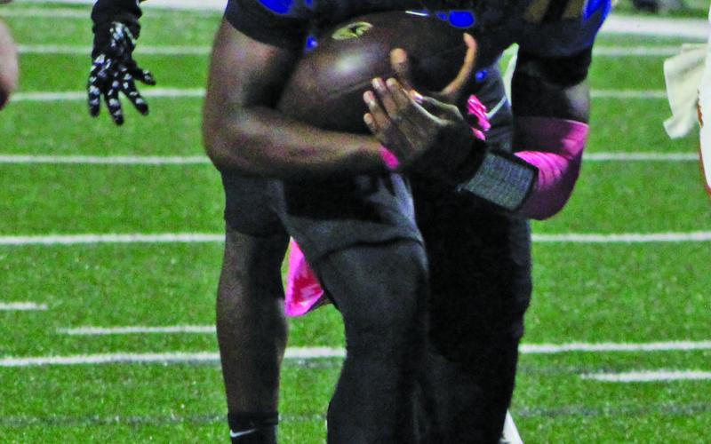 Sentinel Photo/Mike Reddell Bay City quarterback Keimarion Wiggins (2) barrels ahead for a Blackcat touchdown.