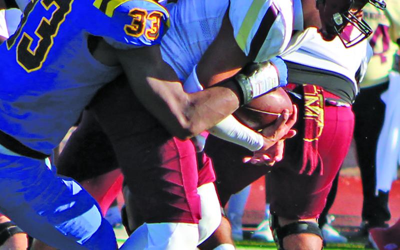 Sentinel Photo/Mike Reddell Senior defensive end Jordan O’neal  (33)  tackles a Tuloso-Midway running back.