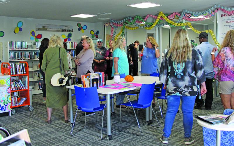 People mingle and talk before the Sargent Community Center groundbreaking begins Monday afternoon, Nov. 3. Sargent residents welcome the construction of the new center that will be built behind the present library. Ultimate plans call for the library to be located in the Community Center. Sentinel Photo/ MaLinda Reddell