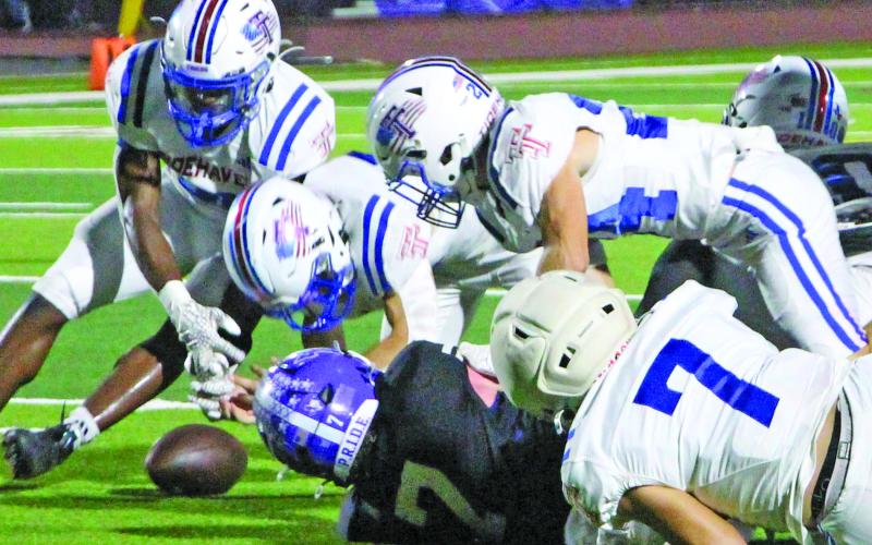 Sentinel Photo/MaLinda Reddell Several Tidehaven defenders help bring down the Stockdale quarterback and cause a fumble in the area game against Stockdale.