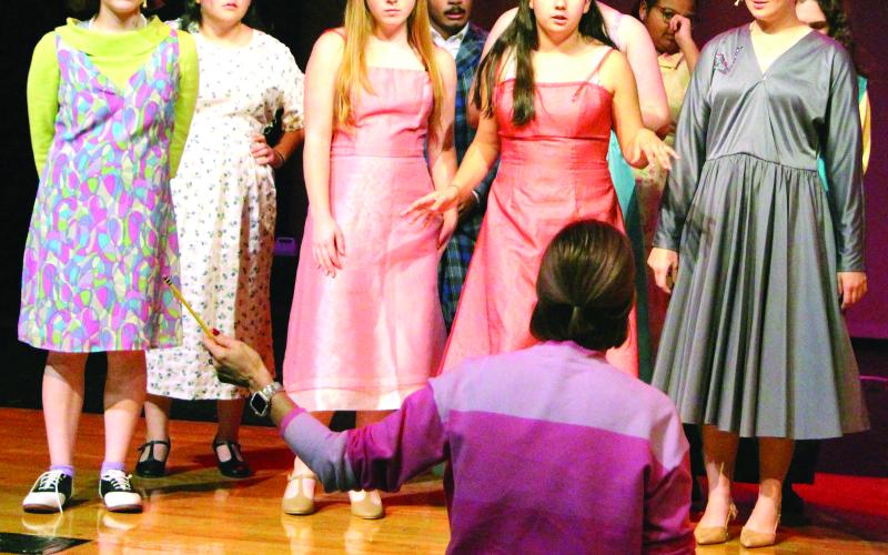 Sentinel Photo/Jessica Shepard Bay City High School Director of Choirs Dr. Kara Cowart, center, helps "Hairspray: The Broadway Musical" cast members through choreography and vocal rehearsals Monday night. The musical is set to start at 7 p.m. Friday, Dec. 5