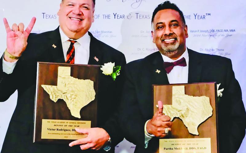 Texas A&amp;M photo Dr. Victor Rodriguez of Houston, left, and Dr. Partha Mukherji, a former Bay City resident, shared Texas Dentist of the Year honor. Both flash the well-known signs of their respective schools.