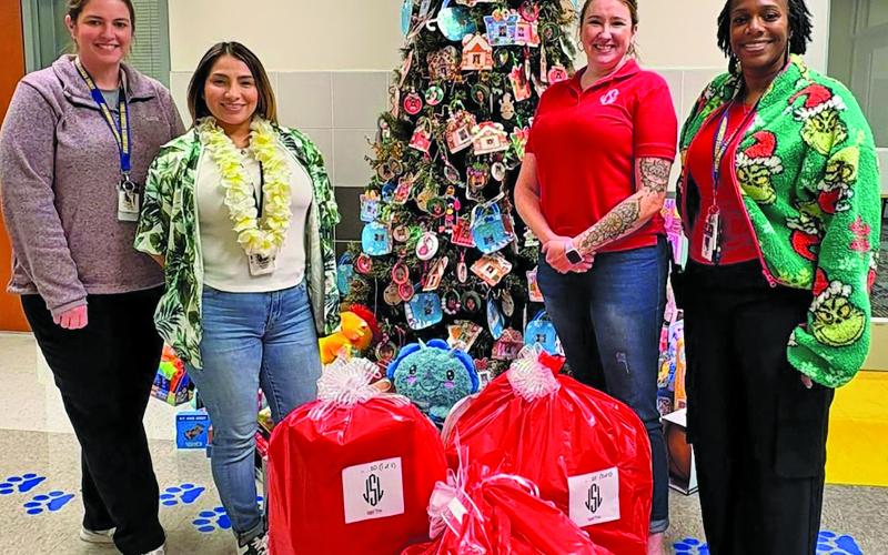 JSL photo Junior Service League’s annual JSL Angel Tree project was completed, with volunteers wrapping hundreds of gifts and delivering Christmas cheer to 64 students across 13 local schools.
